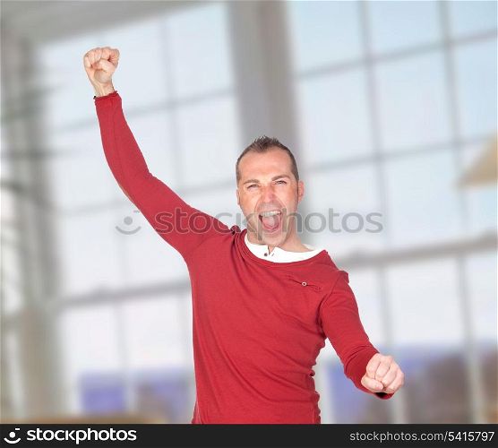 Winner man celebrating something with a window of background