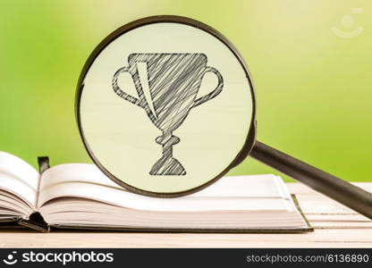 Winner statistics with a pencil drawing of a trophy in a magnifying glass