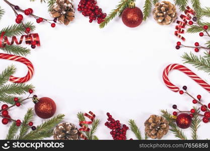 Winter and Christmas frame composition with blank white background, fir tree branch holly berries and pine cones isolated with copy space. Christmas background with decoration