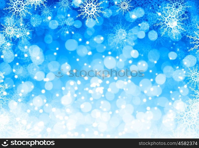 Winter background. Blue Christmas background with snowflakes and lights