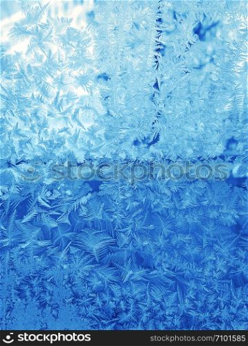 Winter background with beautiful ice pattern on glass