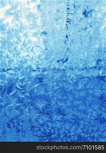 Winter background with beautiful ice pattern on glass