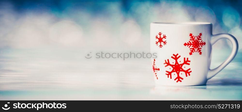 Winter background with mug with snowflakes on blue bokeh , front view