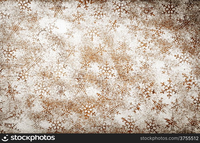 Winter background with snowflakes for Christmas. Snowflake pattern made ??of icing sugar on wooden table. Top view