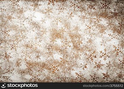 Winter background with snowflakes for Christmas. Snowflake pattern made ??of icing sugar on wooden table. Top view