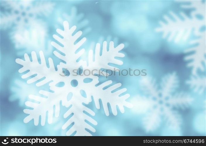 Winter blue background with snowflakes falling.