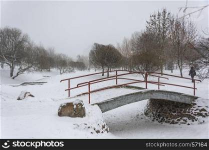 Winter. Bridge over the river in snowy weather