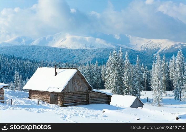winter calm mountain landscape with shed and mount ridge behind (Kukol Mount, Carpathian Mountains, Ukraine)