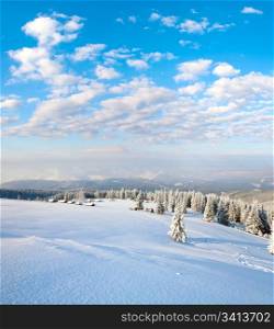 winter calm mountain landscape with sheds group and mount ridge behind (Kukol Mount, Carpathian Mountains, Ukraine)