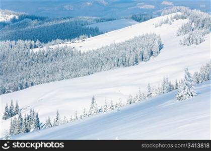 winter calm mountain landscape with sheds group on slope (Kukol Mount, Carpathian Mountains, Ukraine)