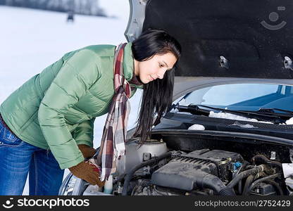 Winter car breakdown - woman try to repair motor