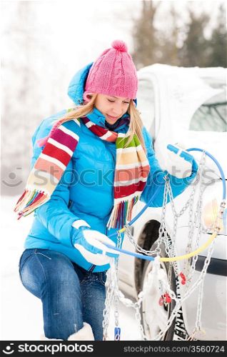 Winter car tire snow chains young woman have problems