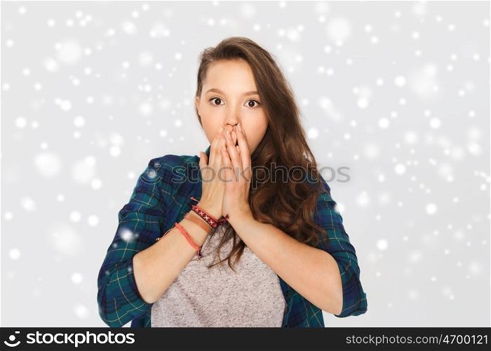 winter, christmas, people, emotion and teens concept - scared teenage girl over gray background and snow