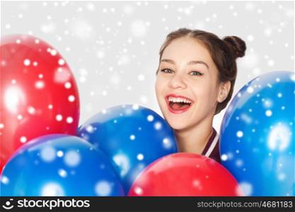winter, christmas, people, holidays and party concept - happy smiling pretty teenage girl with helium balloons over gray background and snow