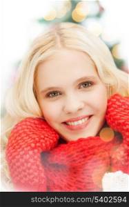 winter, christmas, xmas, x-mas, people, happiness concept - smiling teenage girl in red mittens and scarf