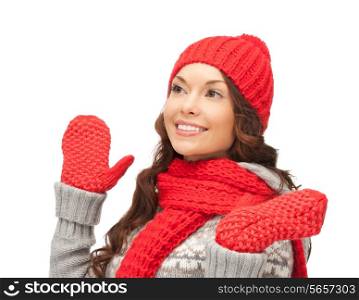 winter clothing, christmas, holidays and people concept - smiling asian woman in red hat, scarf and mittens over white background