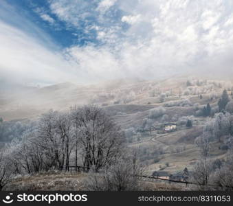Winter coming. Cloudy and foggy morning very late autumn mountains scene. Peaceful picturesque traveling, seasonal, nature and countryside beauty concept scene. Carpathian Mountains, Ukraine.