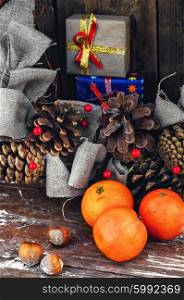 Winter composition with tangerines,pine cones and gifts