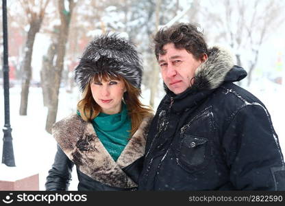 Winter couple walking in snow/ Beautiful adult Caucasian couple