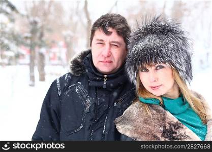 Winter couple walking in snow/ Beautiful adult Caucasian couple