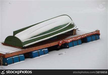 Winter covered with snow rowing boat