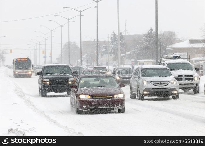 Winter driving. Cars driving on slippery road during heavy snowfall in Toronto
