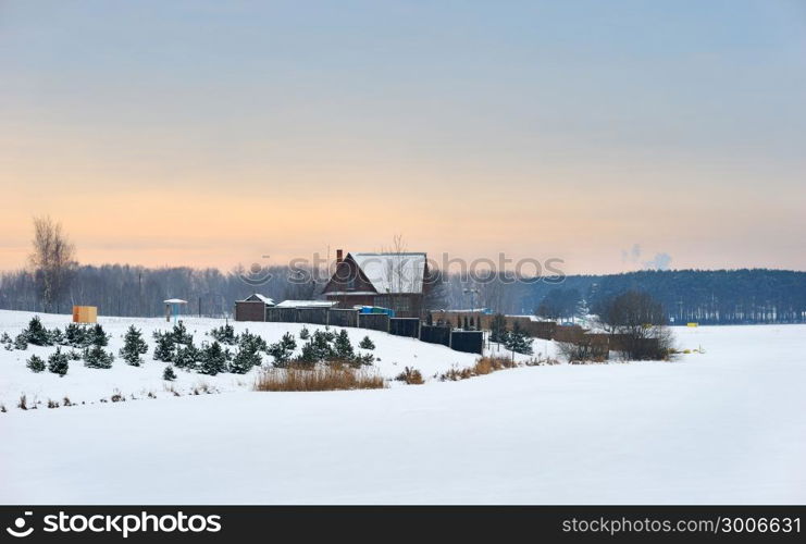 Winter evening on the coast of the frozen lake