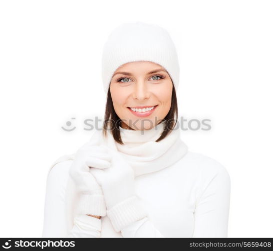 winter fashion andhappy people concept - woman in white hat, muffler and gloves