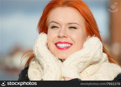 Winter fashion. Beauty face portrait red hair young woman in warm clothing outdoor enjoying sunlight on sunny day.