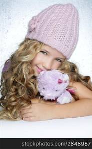 winter fashion cap little girl hug teddy bear smiling silver background