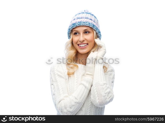 winter, fashion, christmas and people concept - smiling young woman in winter hat, sweater and gloves