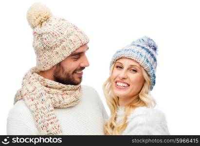 winter, fashion, couple, christmas and people concept - smiling man and woman in hats and scarf