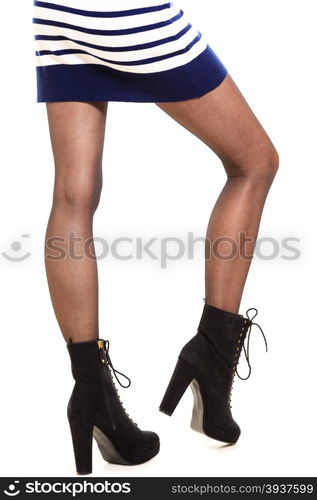 Winter fashion. Female legs foots in stylish fashionable black shoes boots and pantyhose. Studio shot isolated