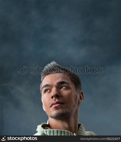 Winter fashion man portrait with frost makeup on dark smoky background