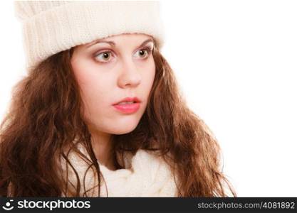 Winter fashion. Portrait of curly girl young woman in warm clothing white hat and scarf isolated. Studio shot.