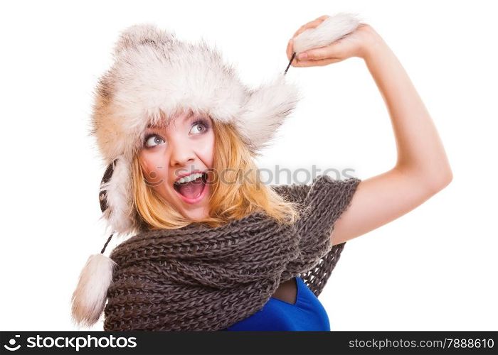 Winter fashion. Portrait positive teen girl in warm clothes. Happy young woman in fur hat doing fun isolated.