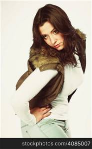 Winter fashion. Young woman plus size model posing in warm waistcoat studio shot.