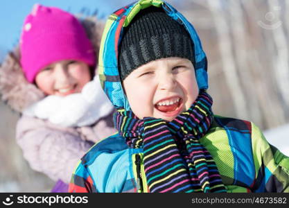 Winter fun. Boy and girl enjoying sledge ride in beautiful snowy winter park