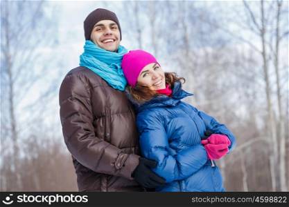 Winter fun. Happy young couple in winter park having fun