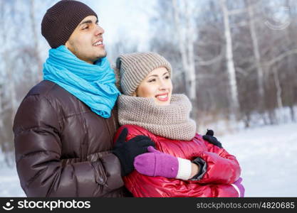 Winter fun. Happy young couple in winter park having fun