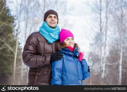 Winter fun. Happy young couple in winter park having fun