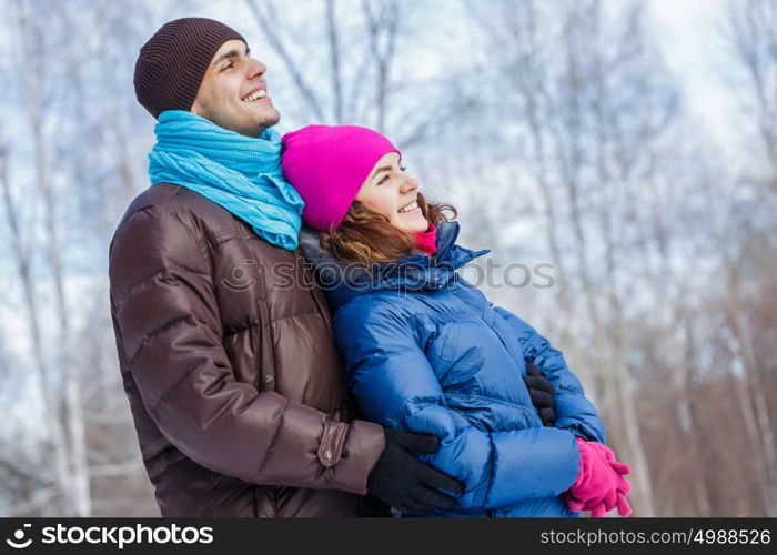 Winter fun. Happy young couple in winter park having fun