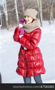 Winter fun. Happy young woman having fun in winter forest
