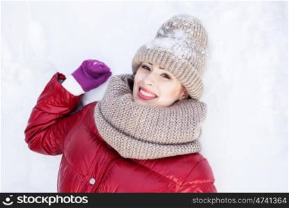 Winter fun. Happy young woman lying on snow in winter forest