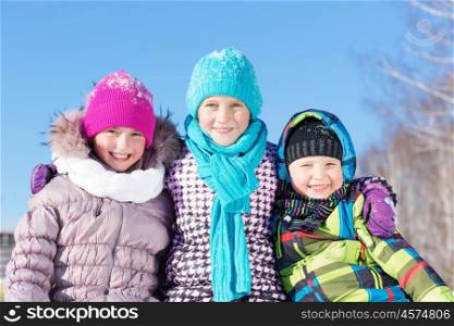 Winter fun. Three children enjoying sledge ride in beautiful snowy winter park