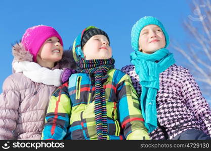 Winter fun. Three children enjoying sledge ride in beautiful snowy winter park