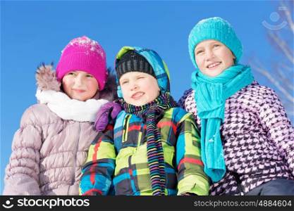 Winter fun. Three children enjoying sledge ride in beautiful snowy winter park