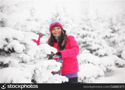 winter girl behind snow tree
