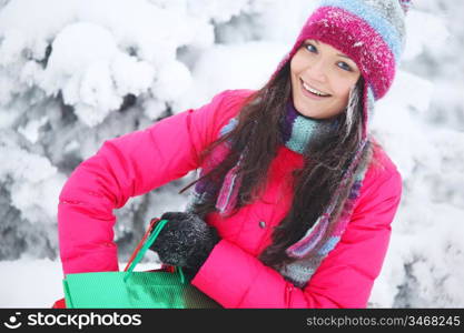 winter girl with gift bags on snow background