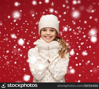 winter, happiness, christmas concept - smiling girl in white hat, muffler and glove